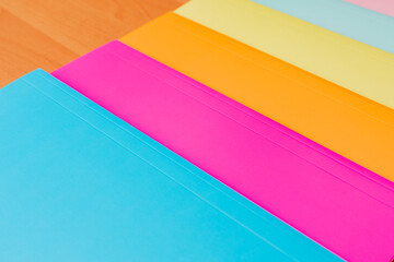 Collection of multi colorful papers lying on the table.
