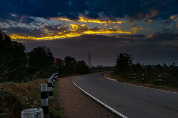 Fototapeta premium Cloudy day with road in the the time of sunrise