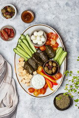 Middle Eastern meze platter with vegetables, crowd and tzatziki sauce