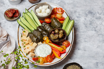 Middle Eastern meze platter with vegetables, crowd and tzatziki sauce