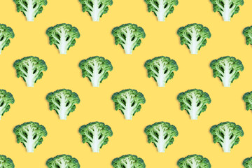 Seamless minimalistic pattern with broccoli cut in half on a yellow background. Photo collage, vegan pop art design, diet,vegetable backdrop healthy food. Print on fabric, wrapping paper. Top view.
