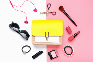 Yellow handbag with woman's accessories. Sunglasses, lipstick, earphones, blush, scrunchy, brushes isolated on pink, white background Top view Flat lay Beauty, fashion, party, shopping concept