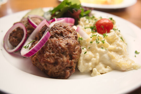 Traditional German meatballs (klopse) served with potato salad 