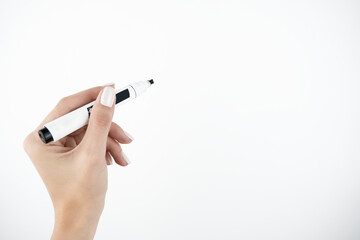 woman's hand holding black marker on isolated white background, teaching and studying concept