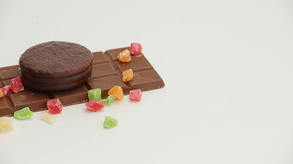 dried fruits, chocolate and chocolate cake on a white background