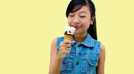 Pretty  girl kid eating licking banana and strawberry ice cream in waffles cone