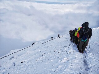 Wan, India - June 2nd 2018: Climbing down from top of the mighty Himalayan Mountain with epic view and a circular Rainbow