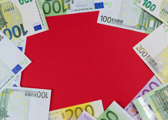 currency of the European Union of different denominations on an red background