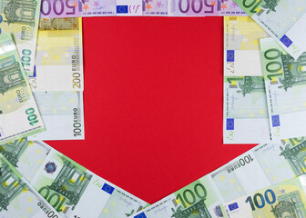 EU currency of different faiths on a red background in the form of a down arrow