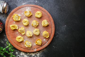 tortellini pasta stuffed ravioli serving size. food background top view copy space for text
