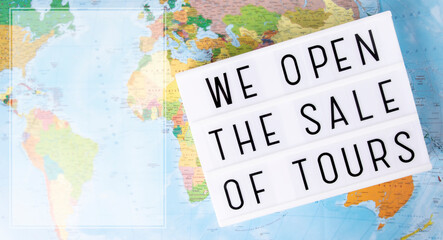 Fototapeta na wymiar Message plate we open the sale of tours on a map background.Top view. Banner.Concept end pandemic,open travel