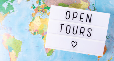 Message about the opening of the sale of tours, the opening of borders. Light box on the background of the map with the message open tours.Top view,banner