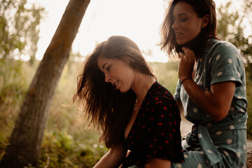 Two young women embraced on the field