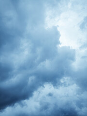 Bright glowing clouds on the blue sky on sunset.
