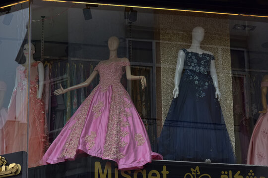 Long elegant and wedding dresses in a shop window