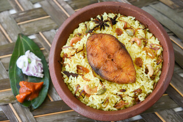 Fish biryani. Spicy and delicious Malabar biryani or Hydrabadi  biryani, Dum Biriyani,  pulao basmati rice, herbs, raitha for Ramadan Kareem, Eid