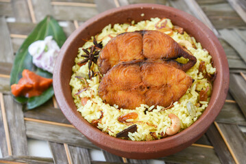 Fish biryani. Spicy and delicious Malabar biryani or Hydrabadi  biryani, Dum Biriyani,  pulao basmati rice, herbs, raitha for Ramadan Kareem, Eid