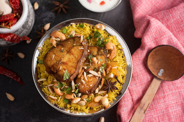Fish biryani. Spicy and delicious Malabar biryani or Hydrabadi  biryani, Dum Biriyani,  pulao basmati rice, herbs, raitha for Ramadan Kareem, Eid