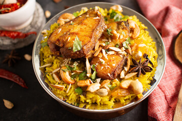 Fish biryani. Spicy and delicious Malabar biryani or Hydrabadi  biryani, Dum Biriyani,  pulao basmati rice, herbs, raitha for Ramadan Kareem, Eid