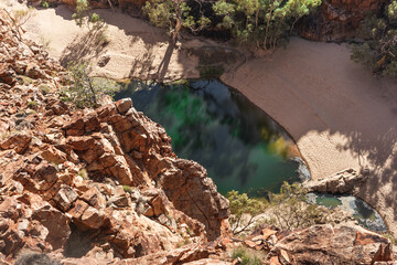 Water pond at Ormiston gorge pictured from above. Gorge with orange and red rocky walls. Macdonnell ranges, Northern Territory NT, Australia, Oceania