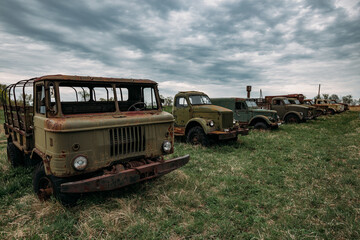 Old rusty truck at abandoned overgrown industrial area