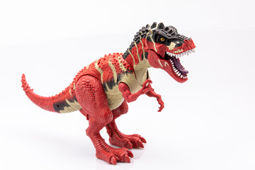 close-up of a colorfull plastic figurine of a tyranosaurus  isolated on a white background