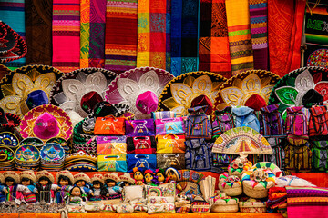 Colorful mexican souvenirs at the market stall at Chichen-Itza archaeological site. - Powered by Adobe