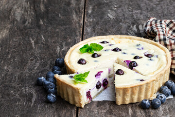 Cheesecake with blueberry on rustic wooden table. Summer dessert
