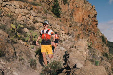 Sport running group of man and woman in cross country trail run