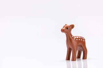 close up of a plastic fawn isolated on a white background