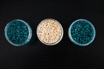 Wax for depilation in banks on a black background. View from above