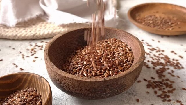 Brown flax seeds in a bowl close up
