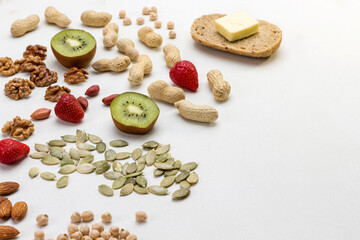 Ingredients for cooking breakfast: Nuts fruits seeds butter roll.