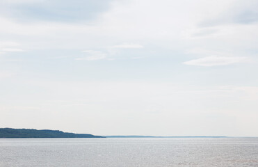 tranquil blue sea against sky with clouds