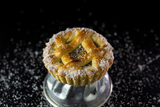 mini pastafrola with sweet potato and grated coconut on black background