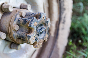 Closeup photo of the SUV front wheel,  covered in mud and clay.