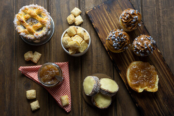 Obraz na płótnie Canvas breakfast snack on wooden table with toast muffins jam pastafrola and cornflour alfajores