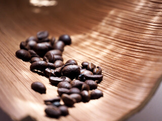 coffee beans in a bag on wooden background.