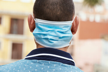 man wearing a surgical mask in his neck