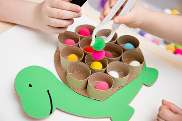 Happy turtle. Sorting game for toddlers. Fill cells with pompoms. Early education, learning colors and counting. Montessori thematic implement for preschool and special needs school