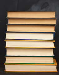 stack of various hardback books