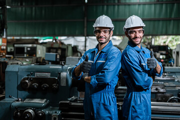 Engineer men wearing uniform safety workers perform maintenance in factory working machine lathe...