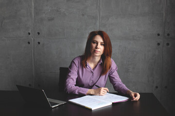 Naklejka premium Young caucasian women work on laptop in modern office or online at home. Office worker. Remote. Online education. 