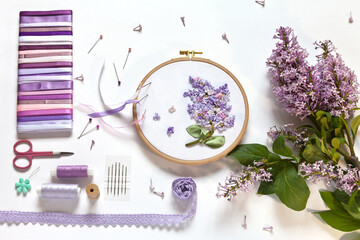 Hand embroidered with satin ribbons branch of blooming lilac in round frame and accessories for...