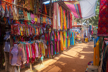Indian bazaar benches with colorful saris - obrazy, fototapety, plakaty