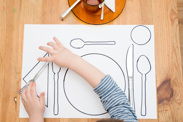 Kid learning to Serve a Table. Task according to Montessori methodology.