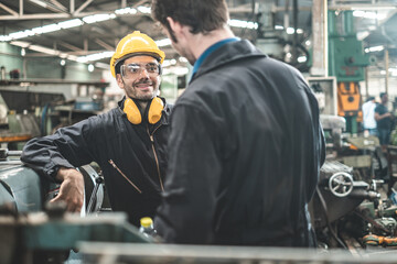 Fototapeta premium Industrial Engineers in Hard Hats.Work at the Heavy Industry Manufacturing Factory.industrial worker indoors in factory. man working in an industrial factory.Safety first concept.
