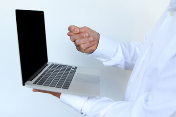 businessman in a white shirt with a laptop in hand, showing a bl