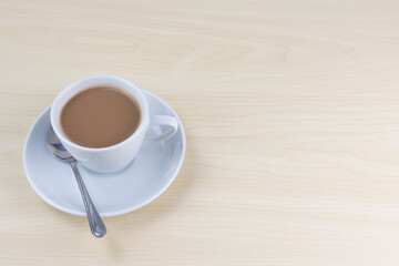 A cup of milk tea isolated on a wooden background.
