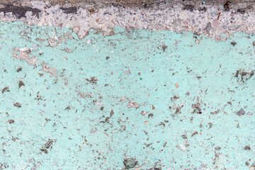 concrete surface covered with paint cracked under the influence of time